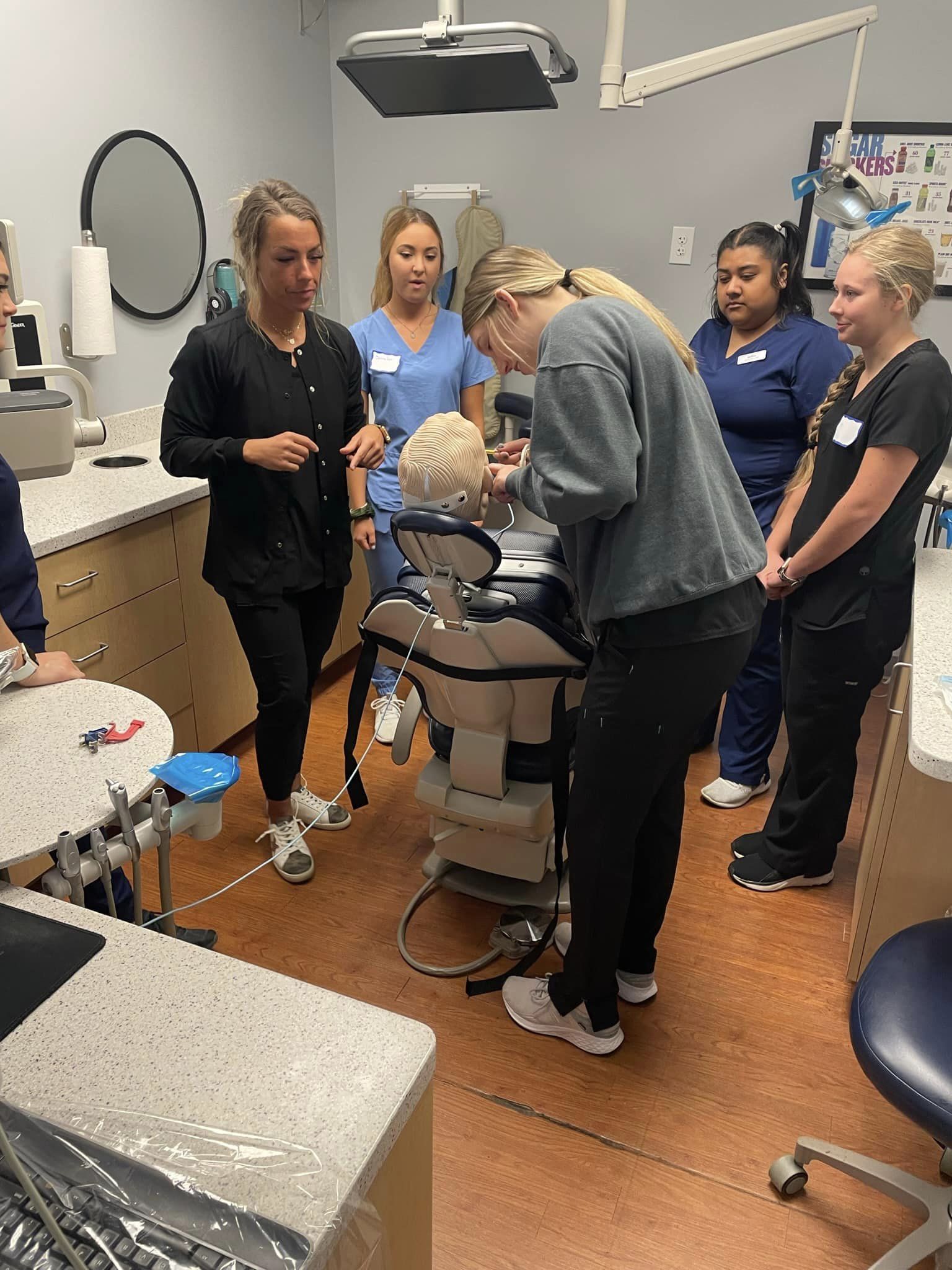 Students at our dental assisting school practicing taking x-rays on a dexter.